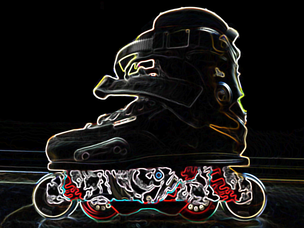 Feet of rollerblader wearing aggressive inline skates grinding on